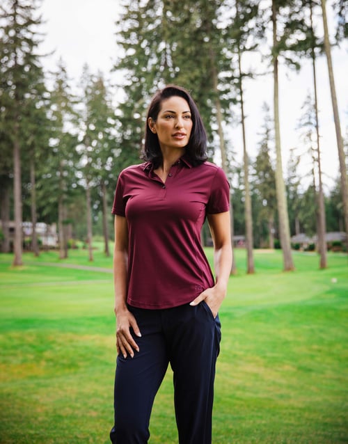 Woman on a golf course wearing Cutter & Buck Prospect Textured Stretch Womens Short Sleeve Polo