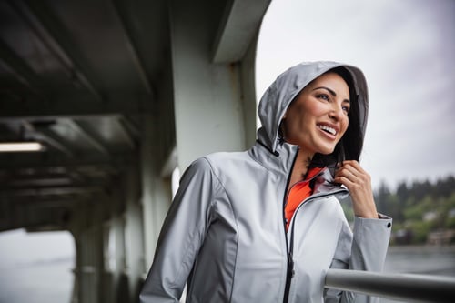 Woman on a boat in the rain wearing Cutter & Buck Vapor Water Repellent Stretch Womens Full Zip Rain Jacket