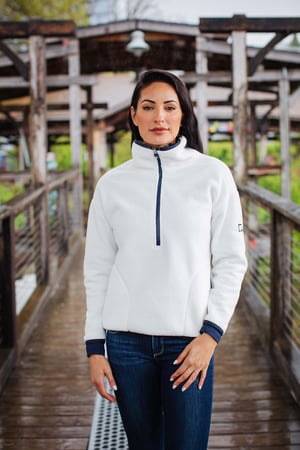 Woman on a bridge outside wearing a cutter and buck sherpa pullover
