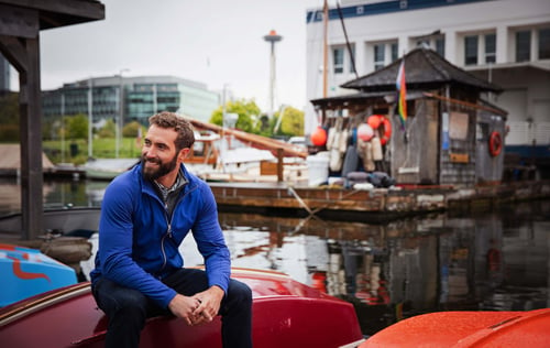 Man on a boat wearing Cutter & Buck Adapt Eco Knit Hybrid Recycled Mens Full Zip Jacket