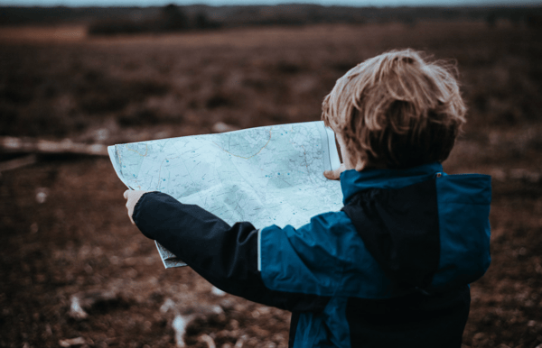 Kid Looking at a Camping Map