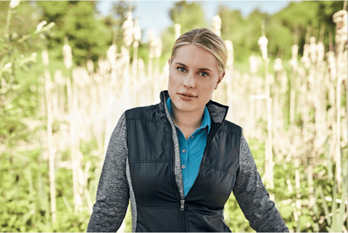 Woman in a field wearing Cutter & Buck Stealth Hybrid Quilted Womens Full Zip Windbreaker Jacket