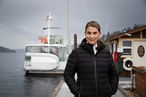Woman outside on dock wearing Cutter & Buck Mission Ridge Repreve® Eco Insulated Womens Puffer Jacket