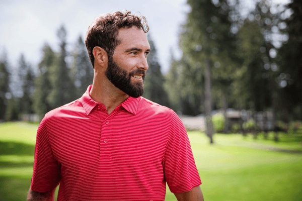 man on golf course wearing a cutter and buck golf polo