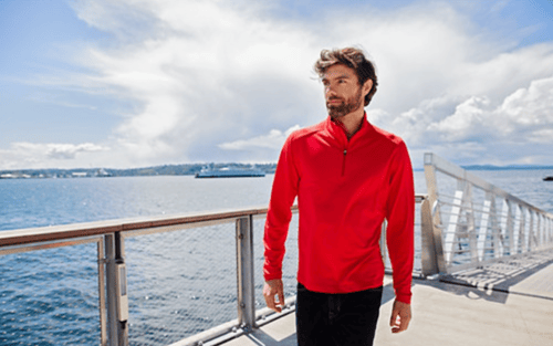 man on boat dock wearing red pullover