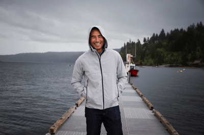 man on boat dock wearing grey water resistant jacket