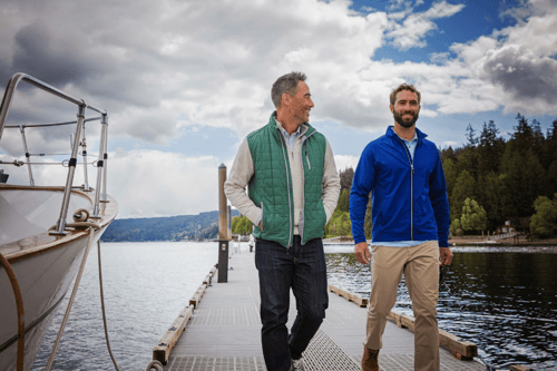 two men walking on a boat dock