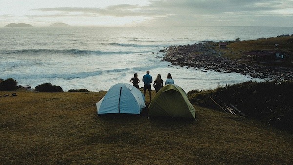 Friends camping by the ocean for National Trails Day
