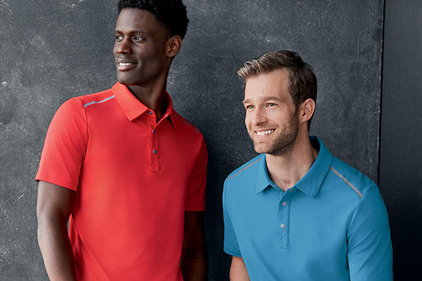 Two men smiling while wearing red and blue Cutter and Buck polos 